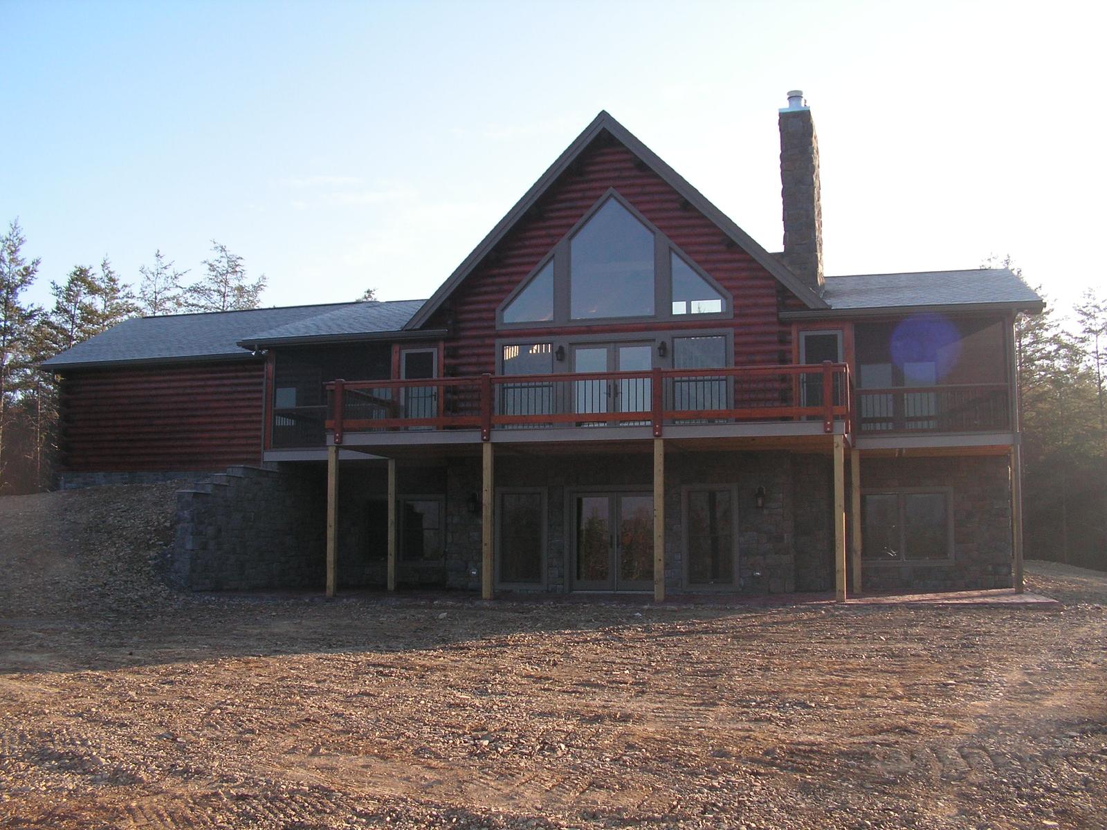 The same elevation in flat evening light, chimney and gable glass above the deck
