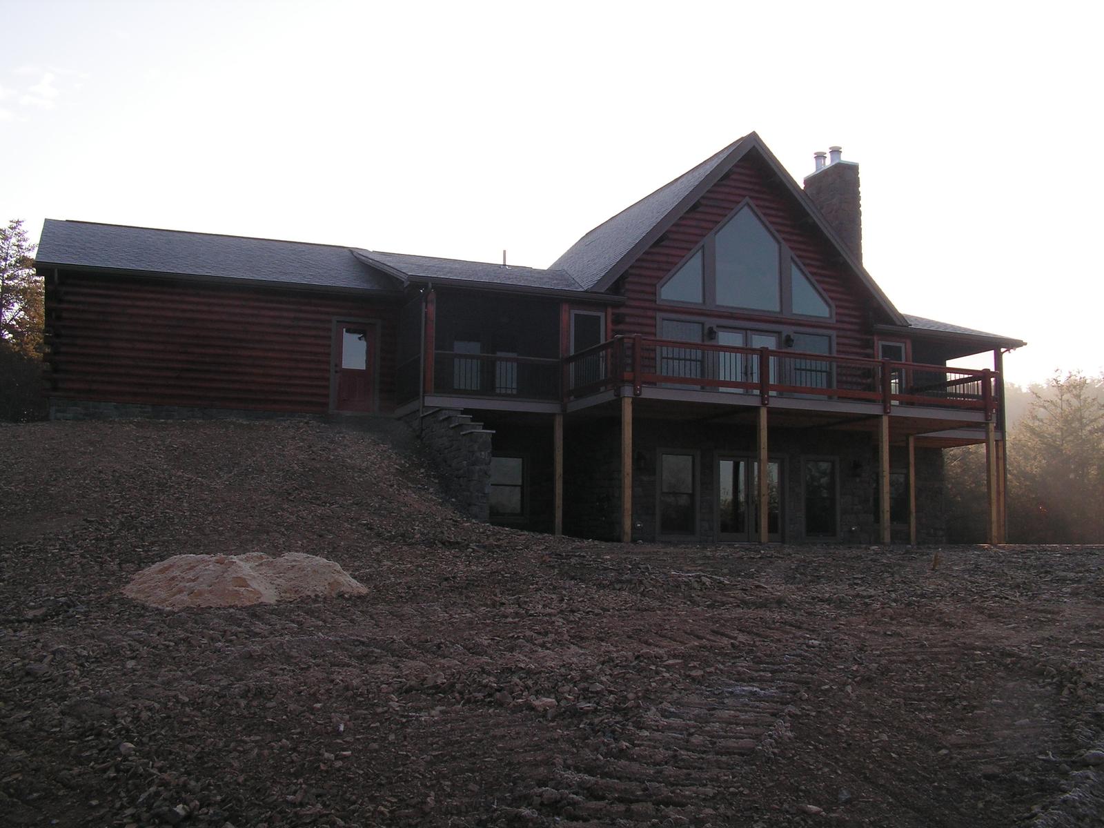 The home from further along the bank, roofline running back from the gable and rough graded ground in front