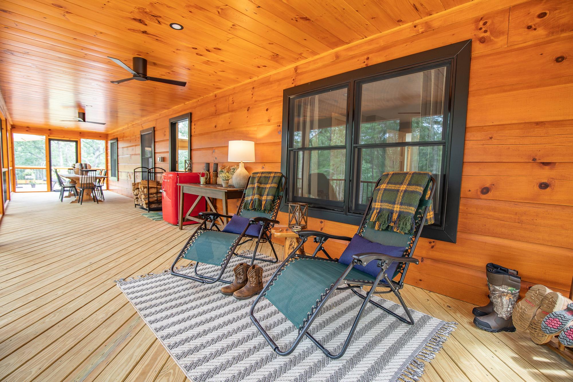 Covered porch with reclining loungers, folded throws and a ceiling fan