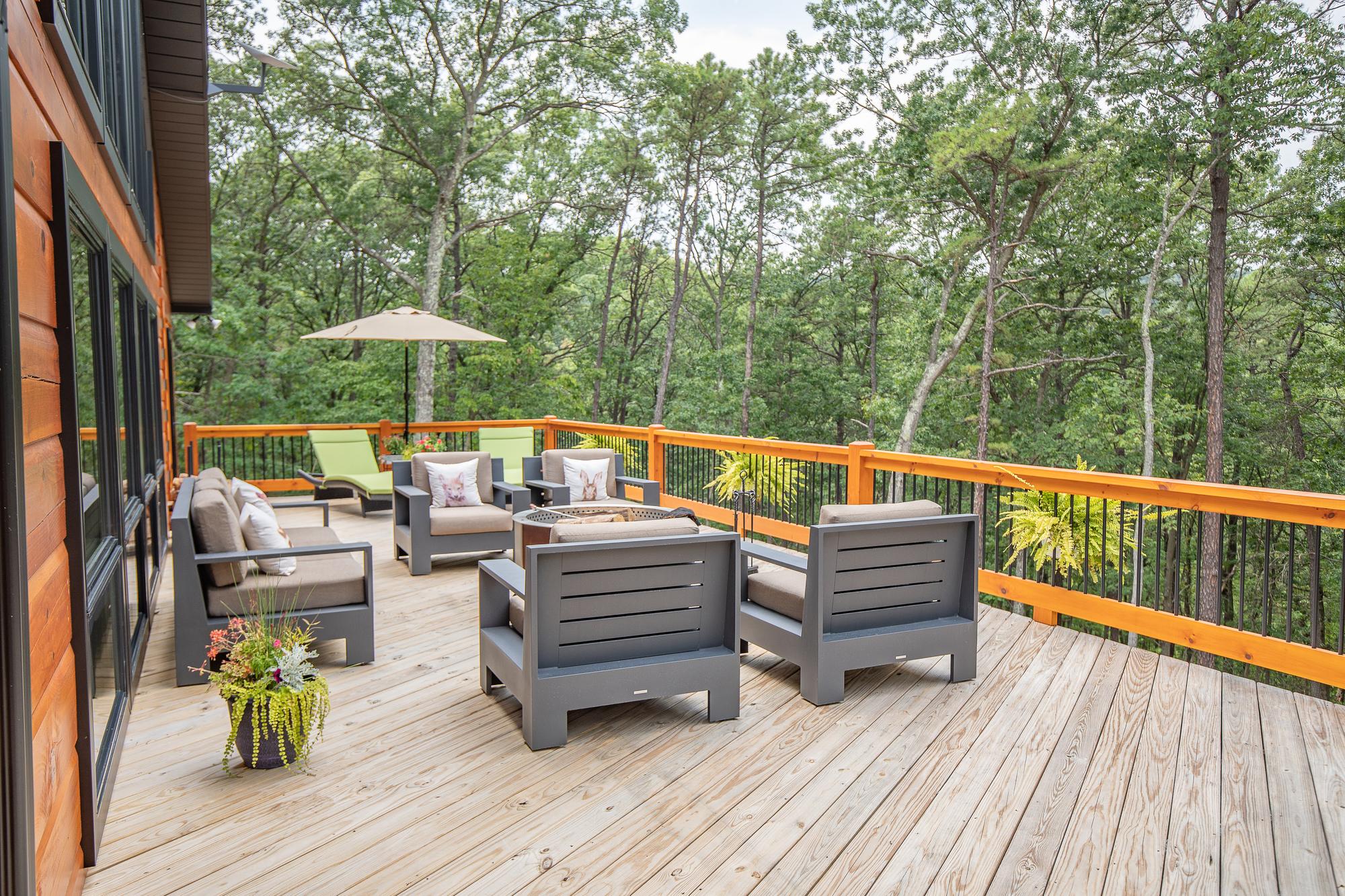 Deck seating with a green lounger beneath a market umbrella