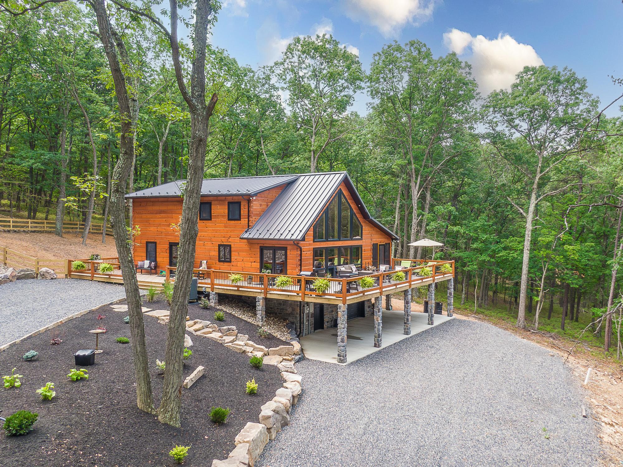 Aerial view of the home framed by a tree trunk in the foreground