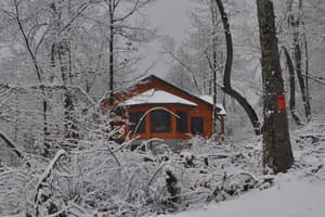 The round room from outside in the snow, its windows catching what light there is.