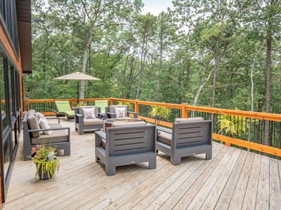 Deck seating with a green lounger beneath a market umbrella