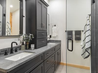 Main bathroom with a double vanity and a glass shower stall