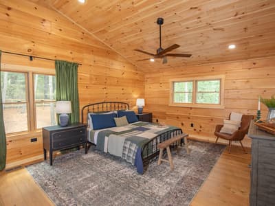 The main bedroom from the opposite corner, showing its windows and dresser