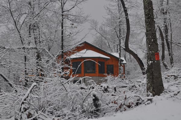The round room from outside in the snow, its windows catching what light there is.