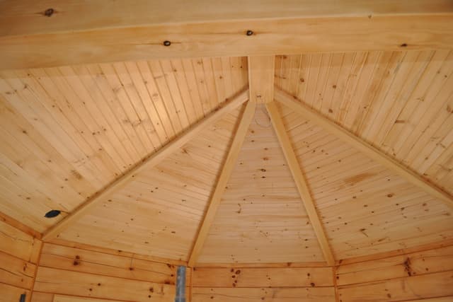 The finished octagon ceiling, boards laid to the radial pattern and converging on the center under warm lights